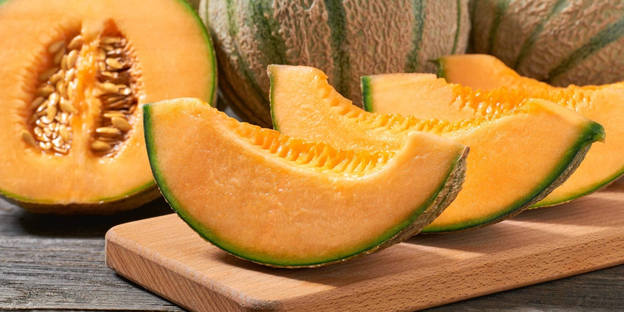 japanese-melon-honey-melon-cantaloupe-melon-cutting-board-rustic-wooden-table