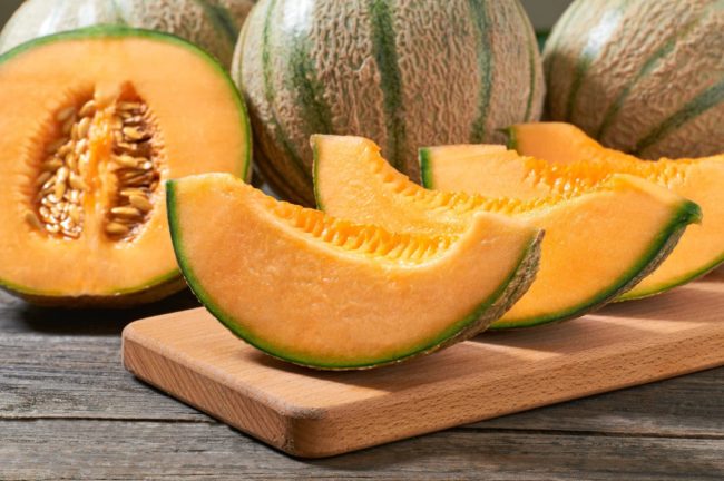 japanese-melon-honey-melon-cantaloupe-melon-cutting-board-rustic-wooden-table